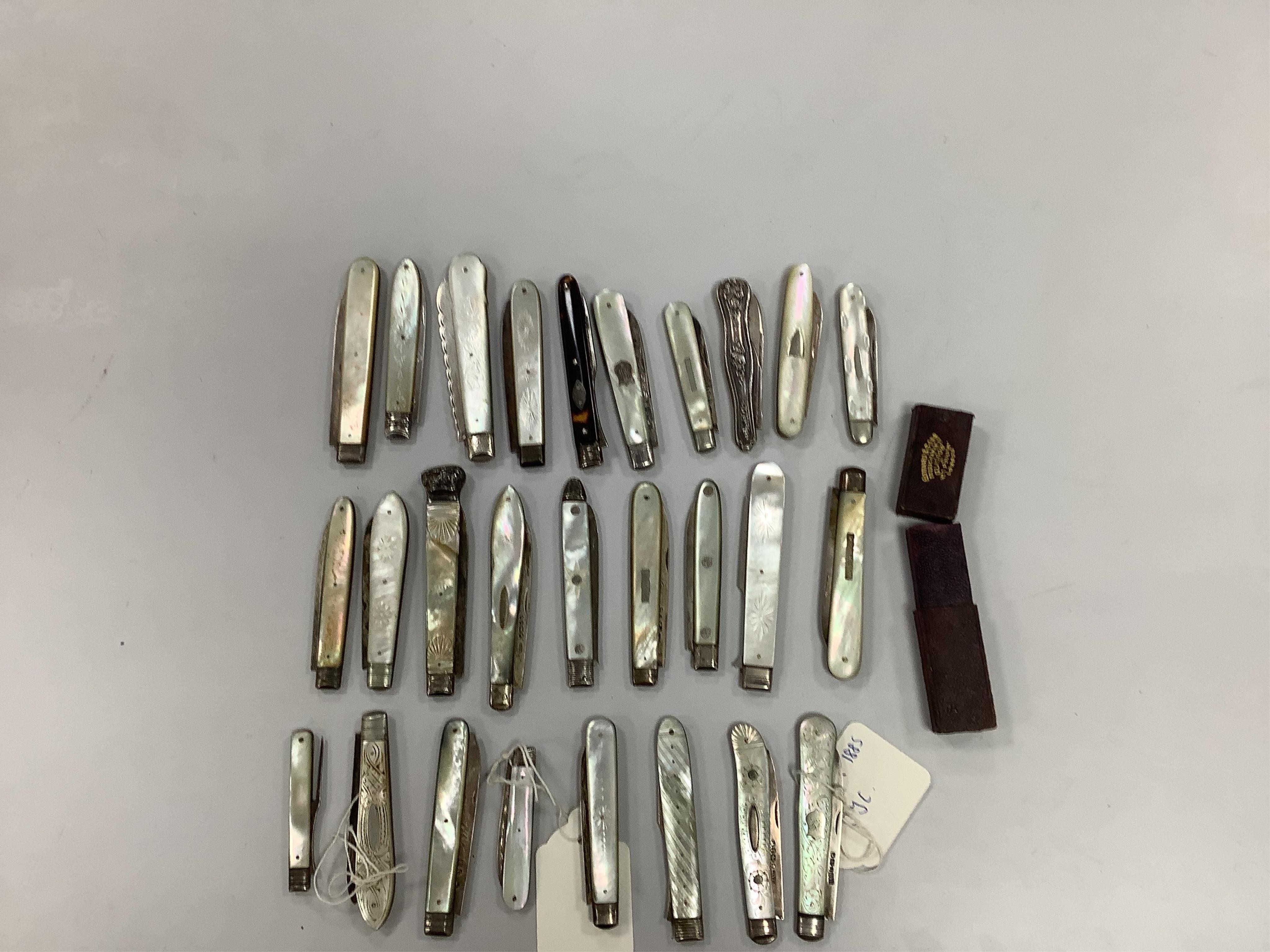 A collection of twenty two assorted mainly Victorian mother of handled silver fruit knives, one with leather case, together with a similar sterling knife and four Georgian silver travelling forks, three with mother of pe